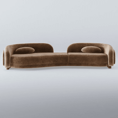 A modular sofa with a distinctive curved silhouette. The sofa is upholstered in a soft, textured fabric and features rounded armrests and backrests. It appears to be composed of two connected sections, creating an S-shaped seating arrangement. Two oval-shaped accent pillows are placed on the seating surface. The base of the sofa is low-profile, with small, rounded legs visible at the front. — 3D model