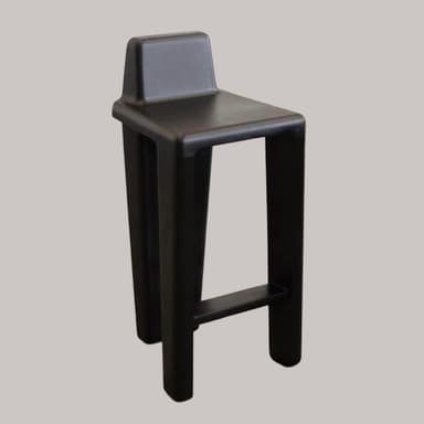 A modern black-stained oak bar stool featuring a minimalist design with an integrated backrest. The stool has a square seat and four robust, slightly tapered legs. A single metal footrest bar connects the front legs. The wood grain is visible beneath the black finish. — 3D model