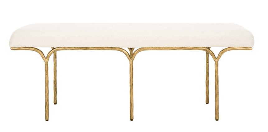 A long, upholstered bench with a rounded top and a slender, artistic metal base. The base features four legs that curve outwards from the underside of the seat, creating an open, sculptural form. The legs have a textured, organic appearance. — 3D model