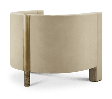 A contemporary armchair with a boxy silhouette and a plush velvet upholstery in a neutral beige tone. The armchair features a high back and armrests that are integrated into the main body, creating a continuous form. The front legs are block-shaped and upholstered, while the rear legs appear to be a decorative, metallic material with an irregular texture. — 3D model