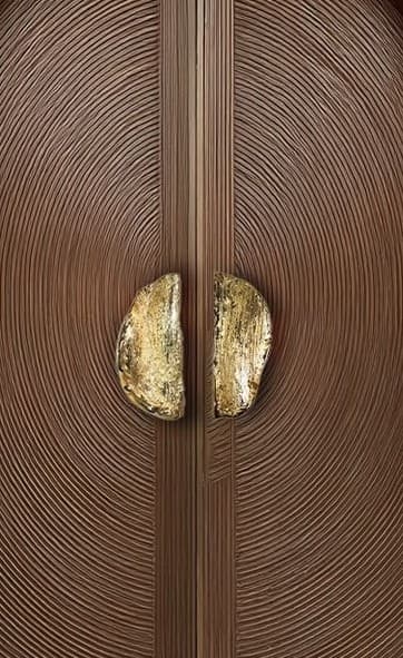 A tall, narrow, rectangular cabinet featuring two doors. The doors are made of dark wood and are adorned with a unique textured pattern of concentric, undulating circles. In the center, where the two doors meet, there are two abstract, organic-shaped handles with a distressed gold or brass finish. The cabinet's design suggests a contemporary or organic modern aesthetic. — 3D model
