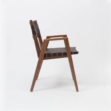 A modern armchair with a wooden frame and woven leather seat and backrest. The frame has clean lines and tapered legs. The seat and backrest are constructed from dark brown leather straps interlaced to form a supportive surface. — 3D model