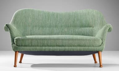 A two-seater sofa with a curvaceous backrest and armrests, upholstered in a textured green fabric. The sofa is supported by four tapered wooden legs that angle outwards. — 3D model