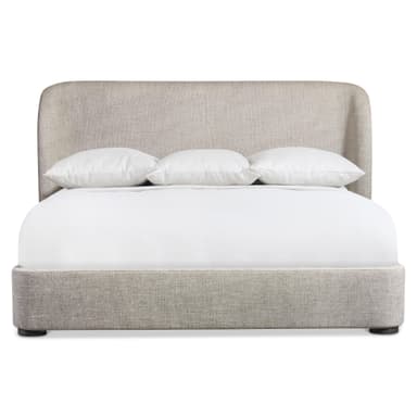 A modern platform bed featuring a fully upholstered frame and headboard in a light beige, textured fabric. The headboard has gently rounded top corners, presenting a soft, contemporary silhouette. The low-profile design is supported by small, dark, cylindrical feet, creating a clean and minimalist aesthetic. — 3D model