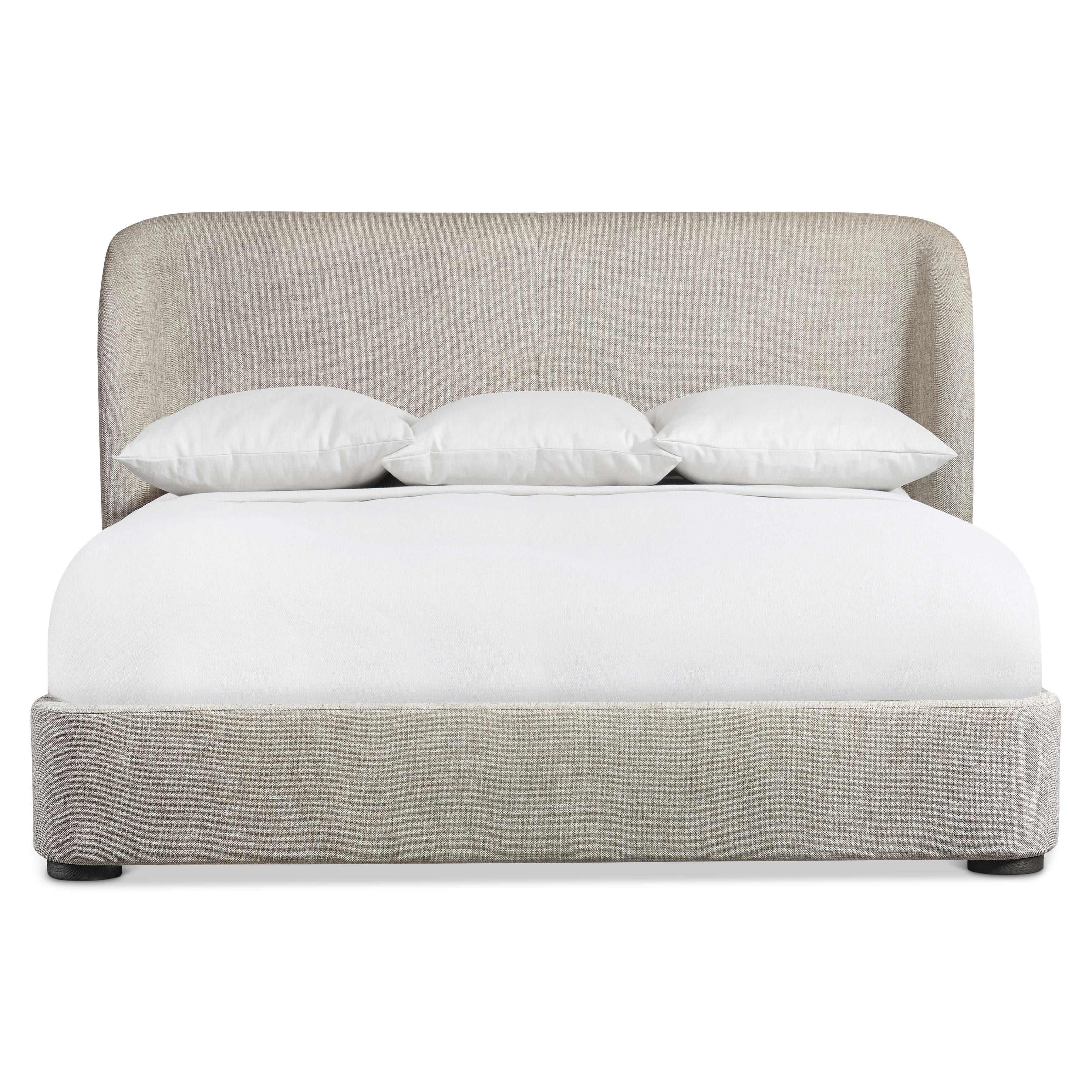 A modern platform bed featuring a fully upholstered frame and headboard in a light beige, textured fabric. The headboard has gently rounded top corners, presenting a soft, contemporary silhouette. The low-profile design is supported by small, dark, cylindrical feet, creating a clean and minimalist aesthetic. — 3D model