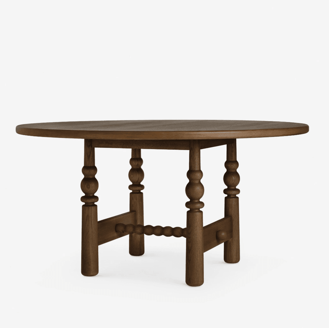 A round dining table constructed from dark-stained wood, featuring a thick circular tabletop supported by four robust, turned legs. The legs are connected by a central, bobbin-turned stretcher, adding structural stability and decorative detail to the base. — 3D model