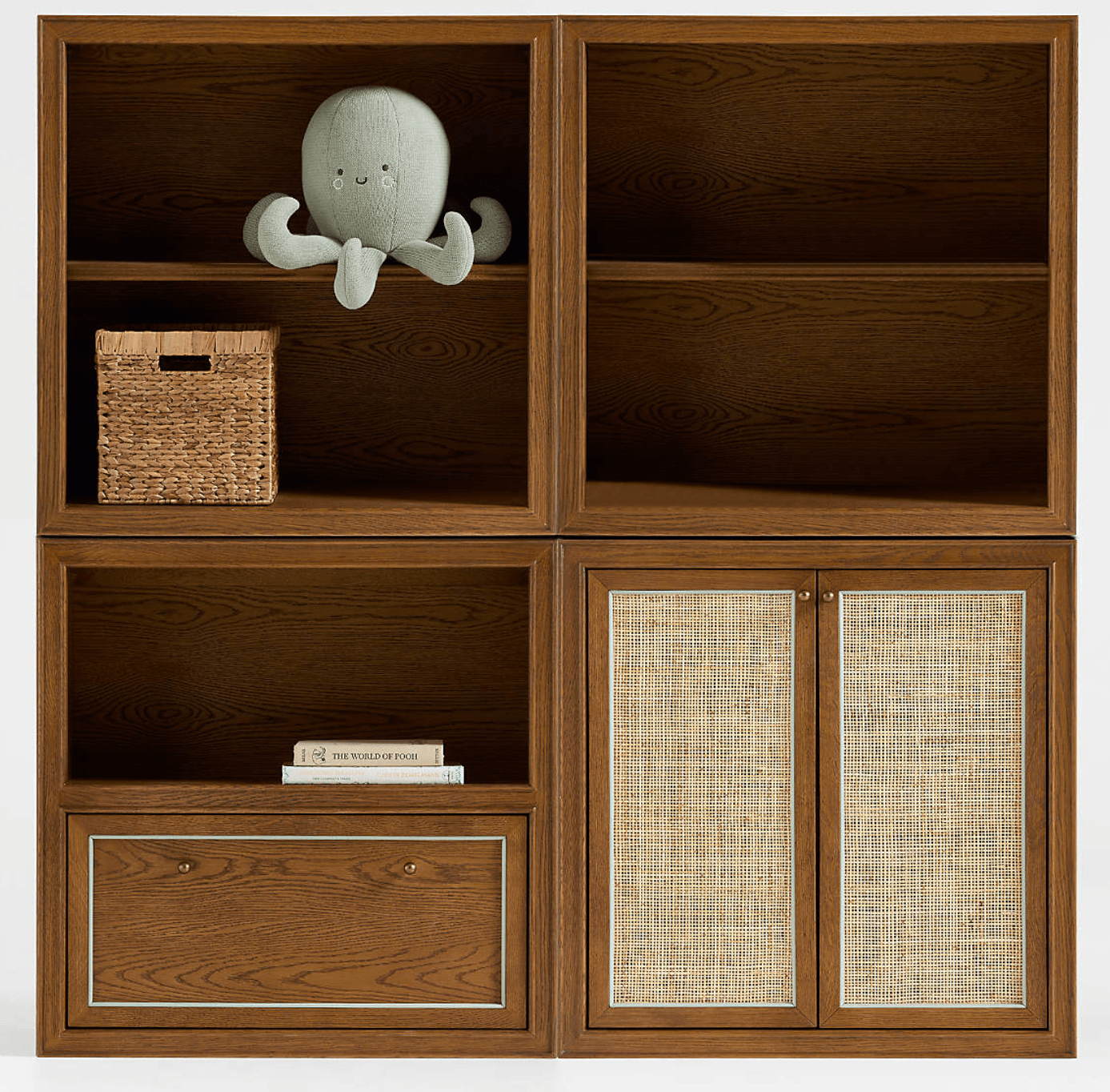 A modern modular storage unit made of medium brown wood, featuring open shelving cubbies in the upper section, a single drawer with small brass knobs, and two cabinet doors with woven cane inserts in the lower section. The wood displays a visible grain pattern, and the unit is presented in an isometric view against a white background. — 3D model
