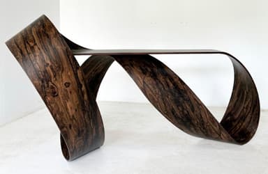 A sculptural console table with a continuous, ribbon-like form, crafted from a dark, heavily-grained wood veneer. — 3D model