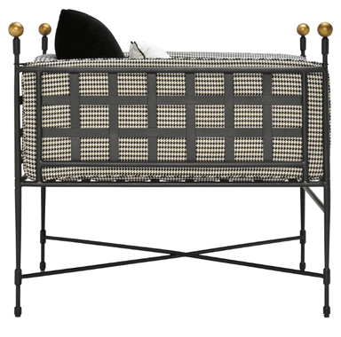 A bench with a dark metal frame and a cushioned seat upholstered in a black and white houndstooth pattern fabric. The backrest is also upholstered with the same fabric and features a grid-like design formed by dark straps. Two spherical finials are visible at the top of the backrest on the left side. — 3D model