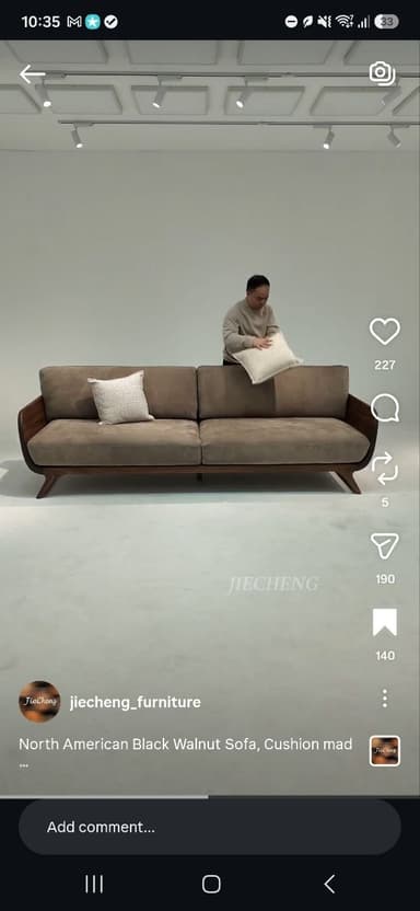 A two-seater sofa featuring a distinctive exposed wooden frame, upholstered in a neutral fabric, and accompanied by two decorative throw pillows. — 3D model