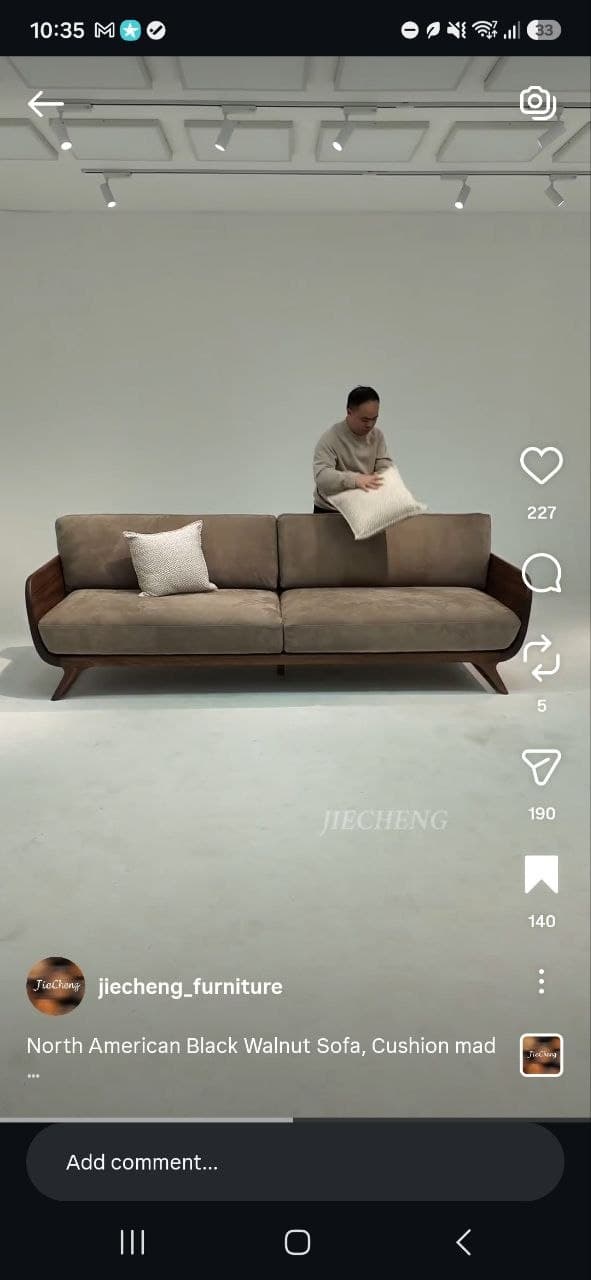 A two-seater sofa featuring a distinctive exposed wooden frame, upholstered in a neutral fabric, and accompanied by two decorative throw pillows. — 3D model