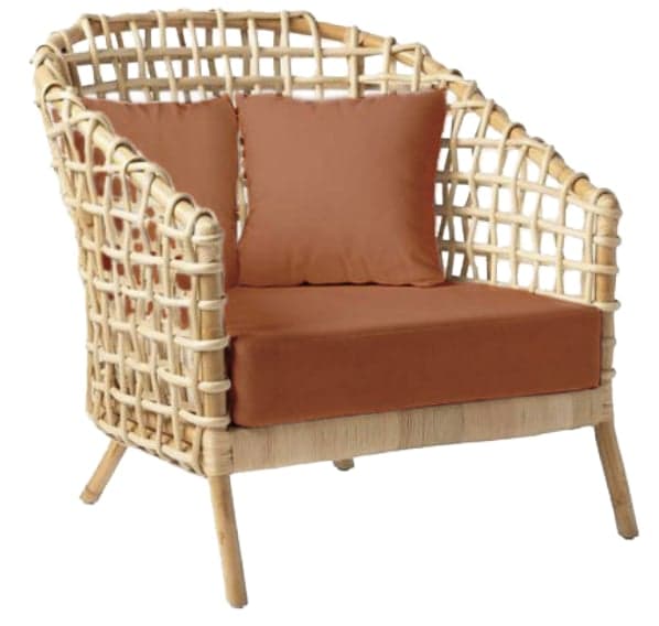 A contemporary lounge chair constructed from natural woven rattan, featuring an open, grid-like pattern on its curved back and armrests. It is furnished with a thick, flat seat cushion and two smaller back cushions, all upholstered in a solid terracotta-colored fabric. The chair rests on four slightly splayed, cylindrical rattan legs. — 3D model