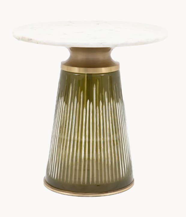 A small, pedestal-style end table featuring a round, white marble top with grey veining. The pedestal base is composed of two sections: an upper, flared metallic bronze element and a lower, conical section made of textured, translucent olive-green glass with vertical fluting. A thin metallic band encircles the base of the glass section. — 3D model