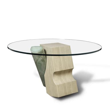 A contemporary coffee table featuring a circular glass top supported by an abstract sculptural base. The base is composed of two distinct elements: one is a light-colored, textured block with carved indentations, appearing to be travertine; the other is a cylindrical element with a veined, translucent green stone, likely onyx, integrated with the first block. The overall design is avant-garde and sculptural. — 3D model