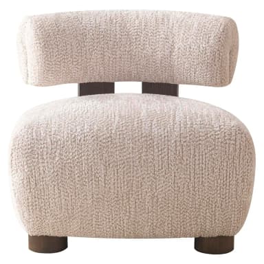 This lounge chair features a low-profile, rounded silhouette upholstered in a textured bouclé fabric. The seat and backrest are generously padded for comfort, with the backrest curving slightly to embrace the user. A dark wood frame is visible behind the upholstered backrest, providing structural support and a visual contrast to the soft upholstery. The chair rests on four short, cylindrical wooden legs, further emphasizing its grounded and sculptural form. — 3D model