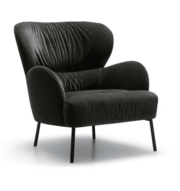 A contemporary armchair upholstered in a dark, textured fabric, featuring a high backrest with prominent vertical ruching. The armchair has wide, curved armrests and is supported by four slender, tapered legs. — 3D model