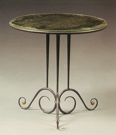 A small, round side table with a dark green glass top and a wrought iron base. The base features three slender legs that curve outwards and are connected by decorative scrollwork with small brass accents. — 3D model