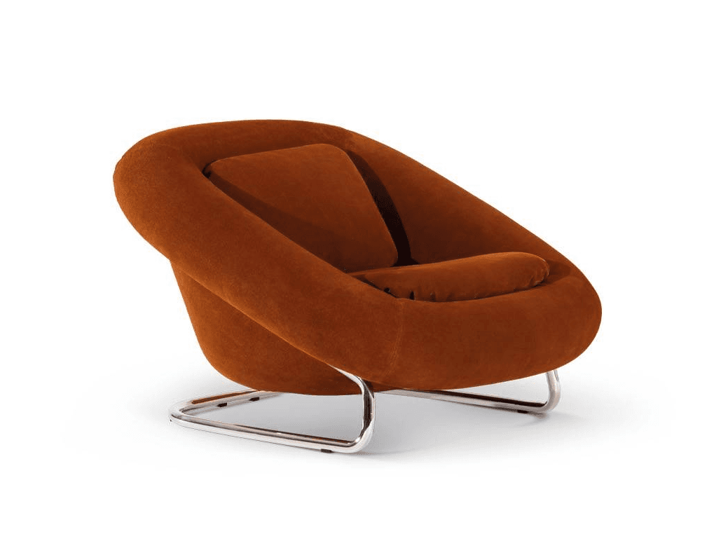 A contemporary armchair with a rounded, enveloping silhouette. The seat and backrest are integrated into a single molded form, upholstered in a textured, rust-colored fabric. It features two separate plush cushions: one for the back and one for the seat. The armchair is supported by a sleek, C-shaped chrome base. — 3D model