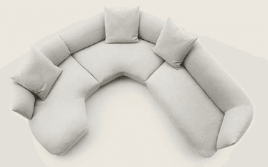 A sectional sofa with a curved, modular design, upholstered in a light-colored, textured fabric. The sofa features multiple seating sections and detached cushions for comfort. It is arranged in a semi-circular configuration, suggesting it is designed for a corner or open-plan space. — 3D model