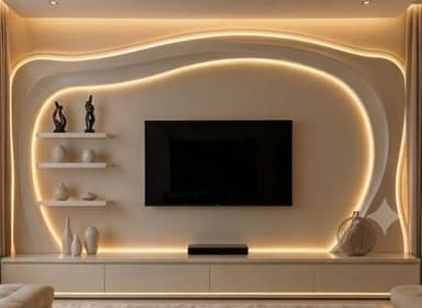 A contemporary, wall-mounted media console featuring a central space for a flat-screen television. The unit is constructed with light-colored panels, possibly engineered wood, and incorporates an abstract, undulating design with integrated warm LED backlighting. It includes a lower floating cabinet with multiple drawers, and a set of small, floating display shelves positioned to the left of the television. Several decorative objects are placed on the shelves and cabinet surface. — 3D model