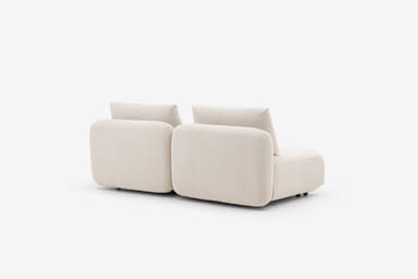 A sectional sofa unit with a low profile, upholstered in a textured, light-colored fabric. The design features rounded armrests and seat cushions, with a modular appearance. Visible stitching details indicate precise construction. The sofa has a contemporary, minimalist aesthetic. — 3D model