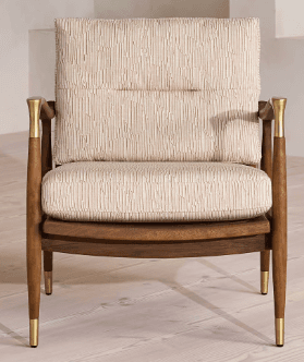 A mid-century modern inspired lounge chair featuring a sturdy exposed dark wood frame, comfortable light-colored upholstered cushions, and elegant brass accents on the armrests and tapered legs. — 3D model