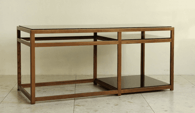 A rectangular coffee table featuring a clear, linear wood frame and two dark, possibly smoked, glass surfaces. The top surface extends across the entire length of the table, while a smaller, square-shaped glass shelf is integrated into the right-hand side of the lower section of the frame. The wooden frame is constructed with clean, straight lines, creating an open and airy aesthetic. The table appears to be in excellent condition, showcasing a modern or contemporary design. — 3D model