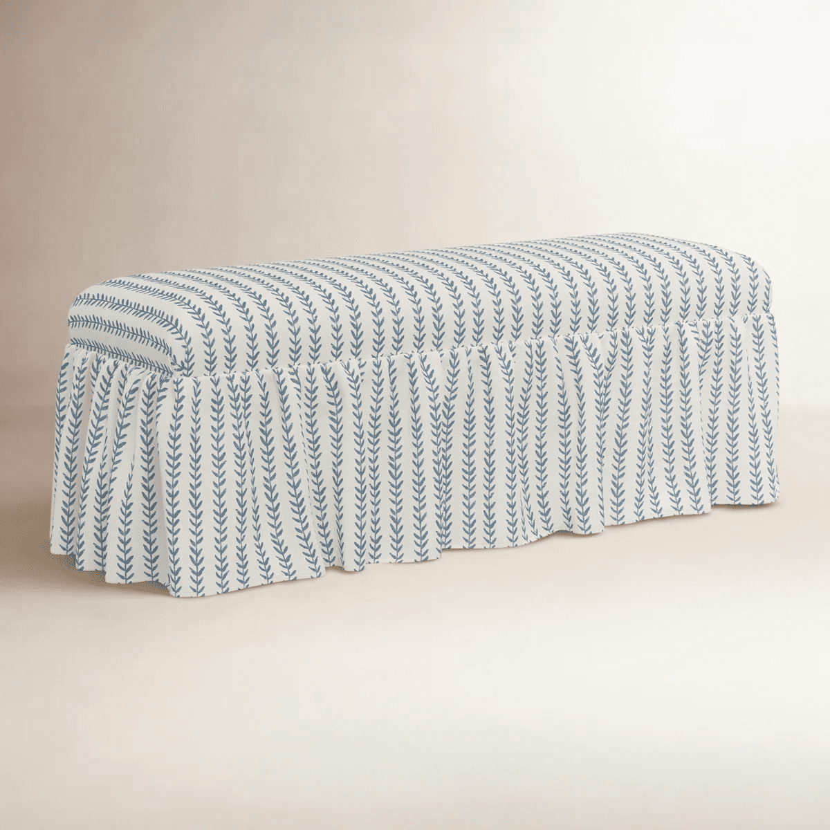 A rectangular bench upholstered with a fabric featuring a repeating pattern of blue vertical sprigs on a cream background. The bench has a skirted base with a ruffled edge that extends to the floor, concealing the legs. The upholstery has a plush, padded appearance. — 3D model