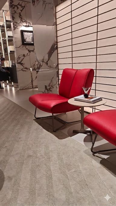 A modern armchair with a low profile and a unique geometric metal base. The seat and backrest are upholstered in red material and feature a quilted or stitched design. — 3D model