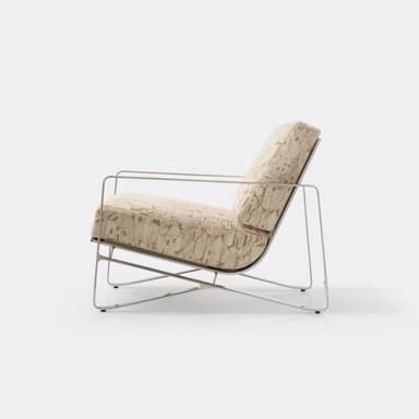 A modern lounge chair featuring a polished metal frame with integrated armrests and supportive back webbing, complemented by thick upholstered cushions in a beige and brown geometric pattern. — 3D model