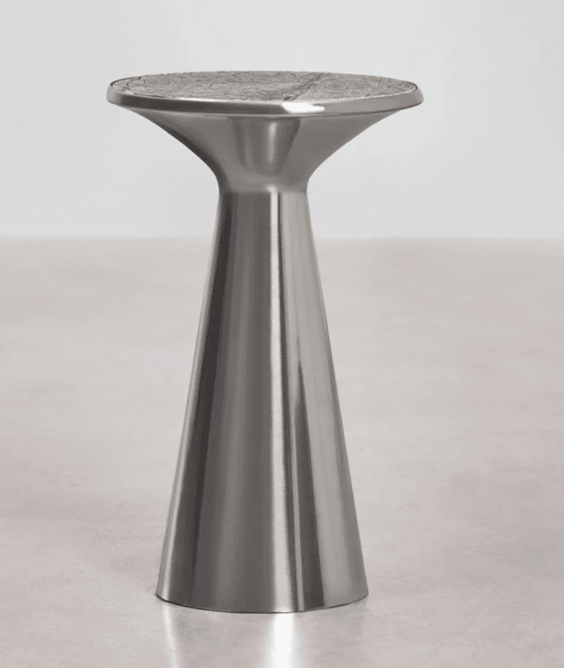 A modern pedestal accent table featuring a brushed metallic finish on its conical base and a round, flat top with a mosaic or patterned inlay. — 3D model