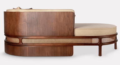 An elegant single-armed chaise lounge featuring a dark walnut wood frame with intricate cane webbing detail and plush upholstered cushions in a neutral beige fabric. — 3D model