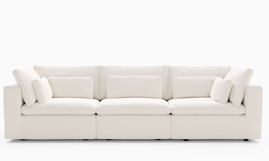 A modern, plush, off-white three-piece modular sectional sofa with deep seats and numerous soft cushions, creating a cloud-like aesthetic suitable for contemporary living spaces. — 3D model