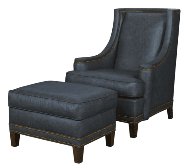 A dark gray, possibly distressed, leather-upholstered wingback armchair with a matching ottoman. Both pieces feature prominent nailhead trim along their edges and stand on short, tapered wooden legs. — 3D model