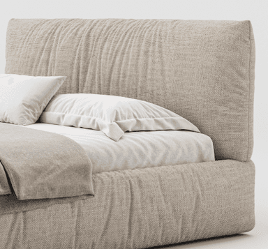 A king-size upholstered bed frame with a plush headboard featuring a ruched or gathered fabric design. The bed is dressed with white bedding, a decorative pillow, and a quilted throw blanket. It sits on a solid base and is flanked by two small, modern side tables, one holding a vase with floral sprigs and the other a cup and saucer. — 3D model