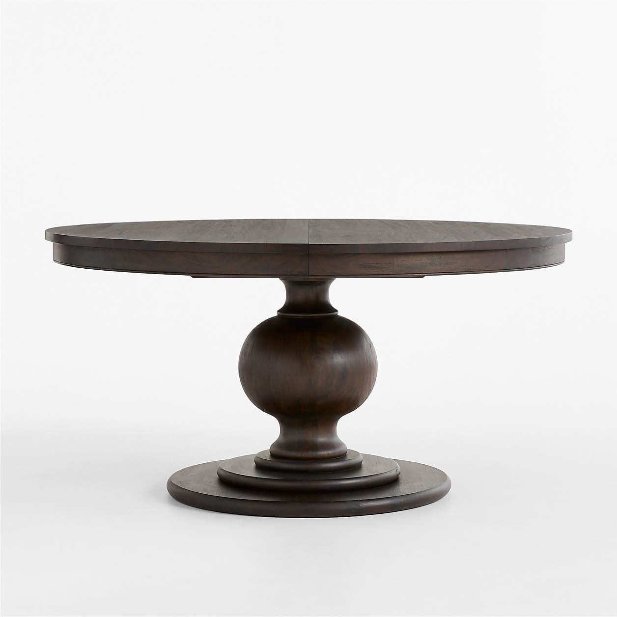 A round dining table constructed from dark-stained wood, featuring a prominent turned pedestal base and a visible seam on the tabletop indicating extendability. — 3D model