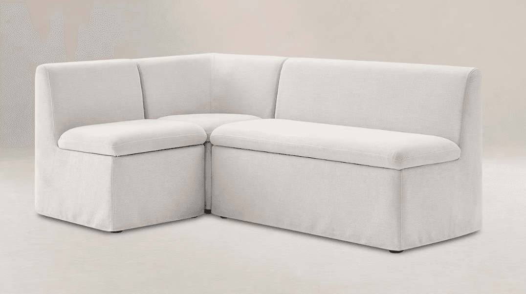An L-shaped upholstered corner seating unit, consisting of multiple modules, featuring a light-colored fabric and clean, minimalist lines. — 3D model