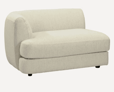 A cream-colored, modular armchair with a curved backrest and armrest. It features a textured upholstery and a low profile base with small black feet. — 3D model