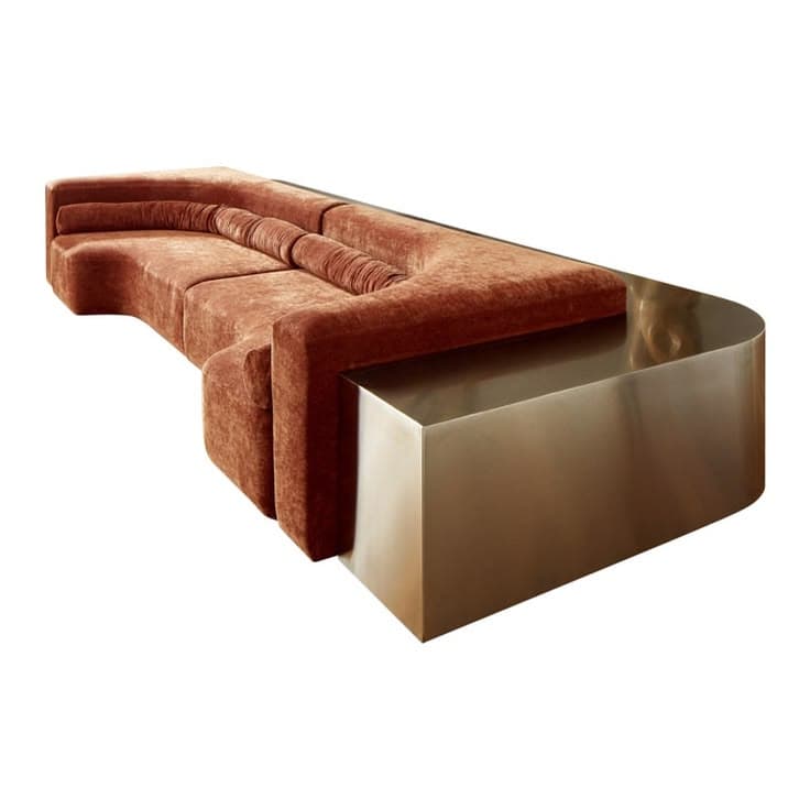 A contemporary modular sectional sofa featuring an L-shaped configuration with plush, rust-colored upholstery and an integrated metallic (likely brass or bronze) side table at one end. The sofa includes soft, cylindrical back cushions. — 3D model