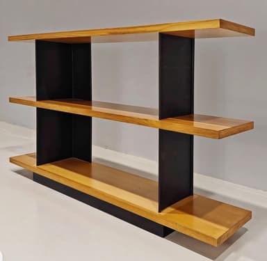 A modern, multi-tiered console table featuring three horizontal wooden shelves supported by contrasting vertical black elements. The top shelf extends over the middle, which in turn extends over the base, creating a cantilevered and layered appearance. The black supports are angled, providing a geometric and stable structure. — 3D model