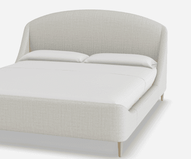 A light-colored upholstered bed frame with a curved headboard and integrated side rails. The bed has a low profile and stands on four slender, tapered wooden legs. It is shown with white bedding, including two pillows. — 3D model