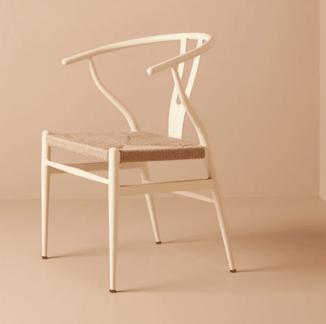 An off-white or cream-colored wooden chair with a distinctive Y-shaped backrest and integrated armrests. The seat is hand-woven from natural fiber, likely paper cord, in a light beige tone. The chair features four slender, tapered legs. — 3D model