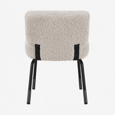 A chair with a plush, textured upholstery and a minimalist metal frame. The seat and backrest are covered in a shaggy, cream-colored material resembling sheepskin or faux fur, creating a soft and inviting appearance. The frame consists of four thin, black metal legs that are angled outwards for stability. Black metal brackets connect the upholstered seat and backrest to the legs, featuring visible screw heads. — 3D model