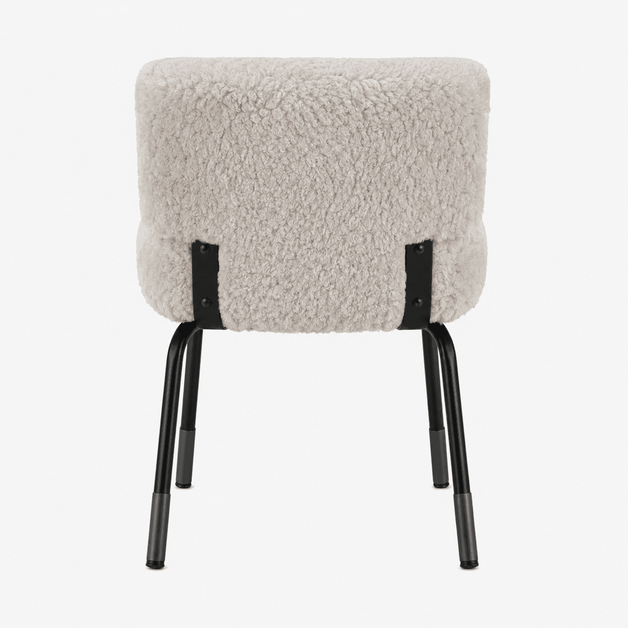 A chair with a plush, textured upholstery and a minimalist metal frame. The seat and backrest are covered in a shaggy, cream-colored material resembling sheepskin or faux fur, creating a soft and inviting appearance. The frame consists of four thin, black metal legs that are angled outwards for stability. Black metal brackets connect the upholstered seat and backrest to the legs, featuring visible screw heads. — 3D model