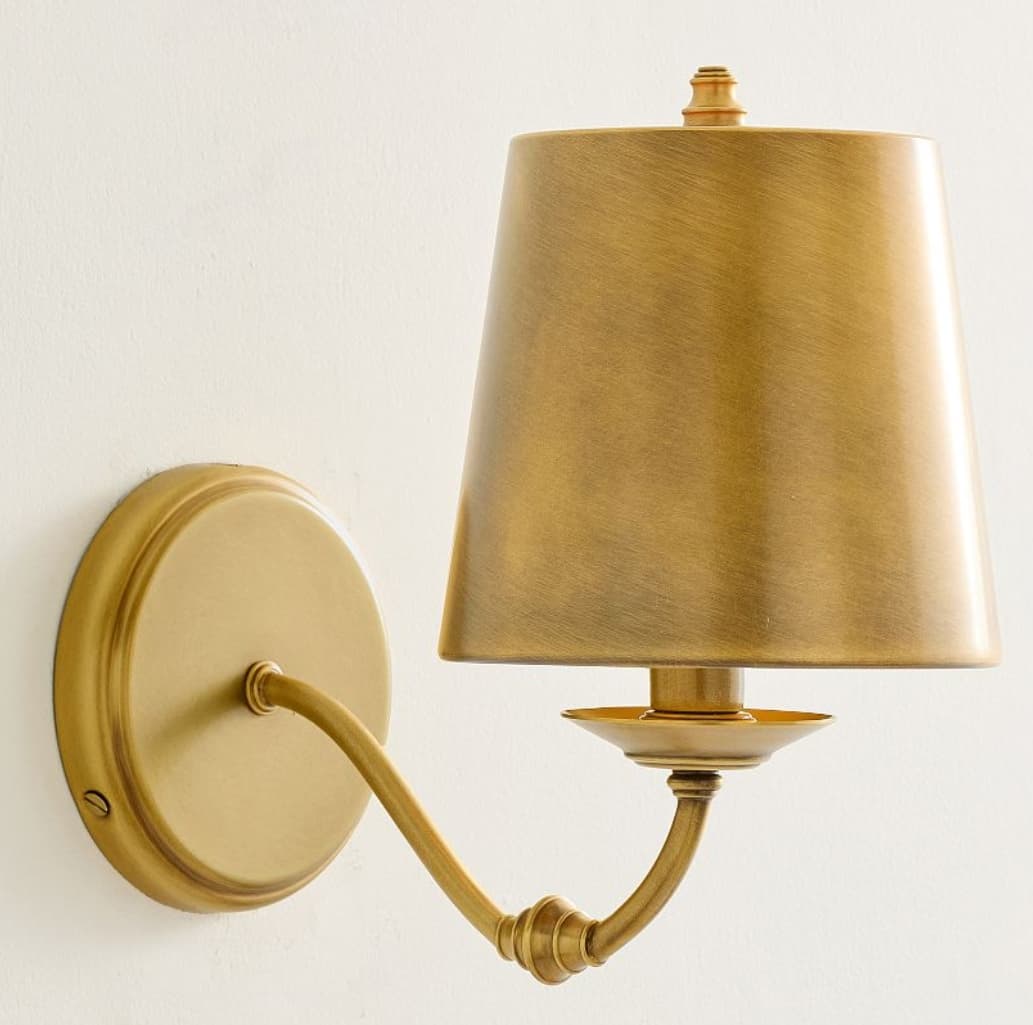 A single-arm wall sconce featuring a conical metal shade with a brushed brass finish, mounted on a round backplate, with an articulated joint on the arm. — 3D model