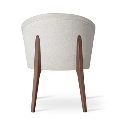 A modern upholstered armchair featuring a curved barrel-back design with integrated armrests and supported by dark wooden legs. The chair is fully upholstered in a light, textured fabric. — 3D model
