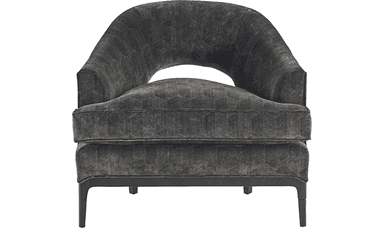A contemporary armchair with a rounded, barrel-shaped back and a deep seat. The upholstery features a subtle geometric pattern. The chair is supported by a dark wooden base and four tapered legs. — 3D model