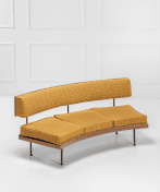 A curved, three-seater sofa with a wooden frame and upholstered cushions and backrest. The sofa features a distinct mid-century modern design, characterized by its clean lines and organic shape. The backrest is elevated by thin metal supports, and the seat is composed of three distinct cushions. The legs are slender and metallic. — 3D model