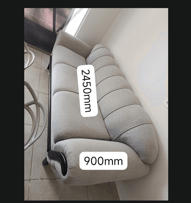 A light grey two-seater sofa featuring a distinctive channel-tufted backrest and two separate seat cushions. The sofa is supported by an exposed dark wooden frame, which extends to form curved accents on the outer portion of the rolled armrests. The design blends traditional elements with a modern sensibility. — 3D model
