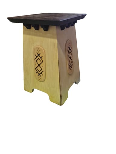A small, light-colored wooden table with a darker square top. The base is tapered and features decorative, carved inserts on its sides, along with small corbel-like details beneath the tabletop. — 3D model
